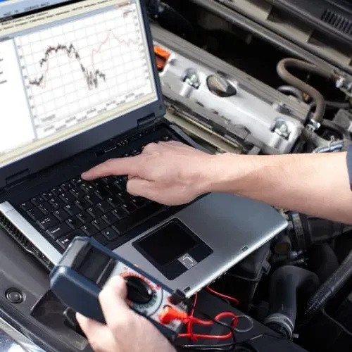 Mobile auto electrician assisting a driver during a roadside electrical emergency